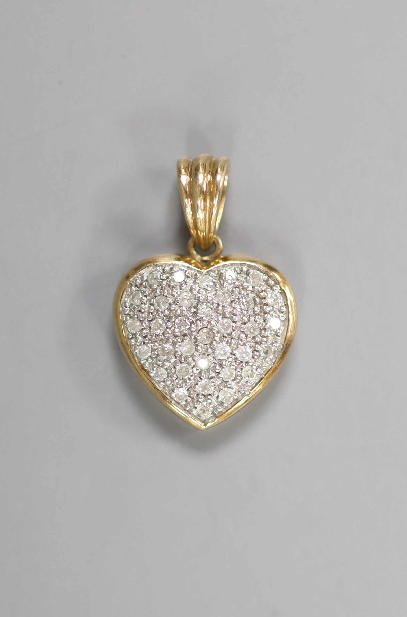 A modern 9k and pave set diamond chip heart pendant, overall 23mm, gross weight 3.3 grams.